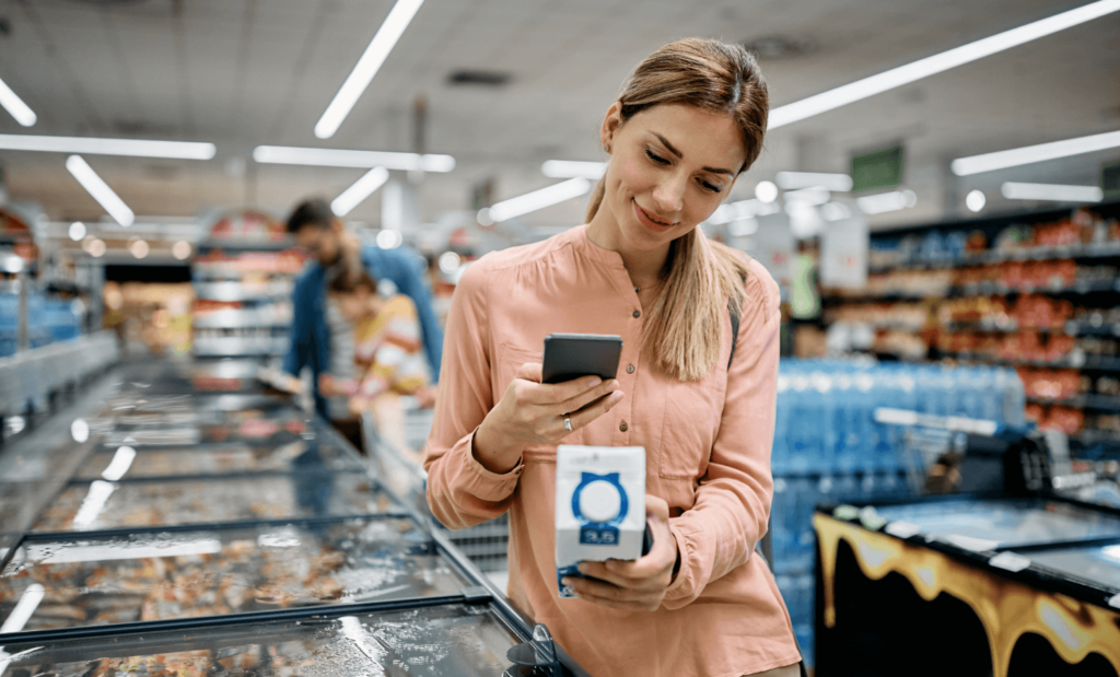 smiling woman scanning qr code on a product while 2023 02 02 20 31 15 utc 1